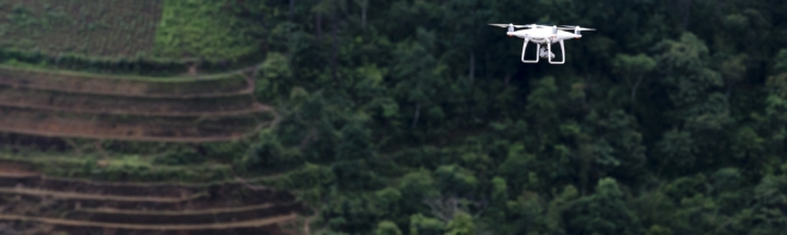 White Drone Flying Above Trees