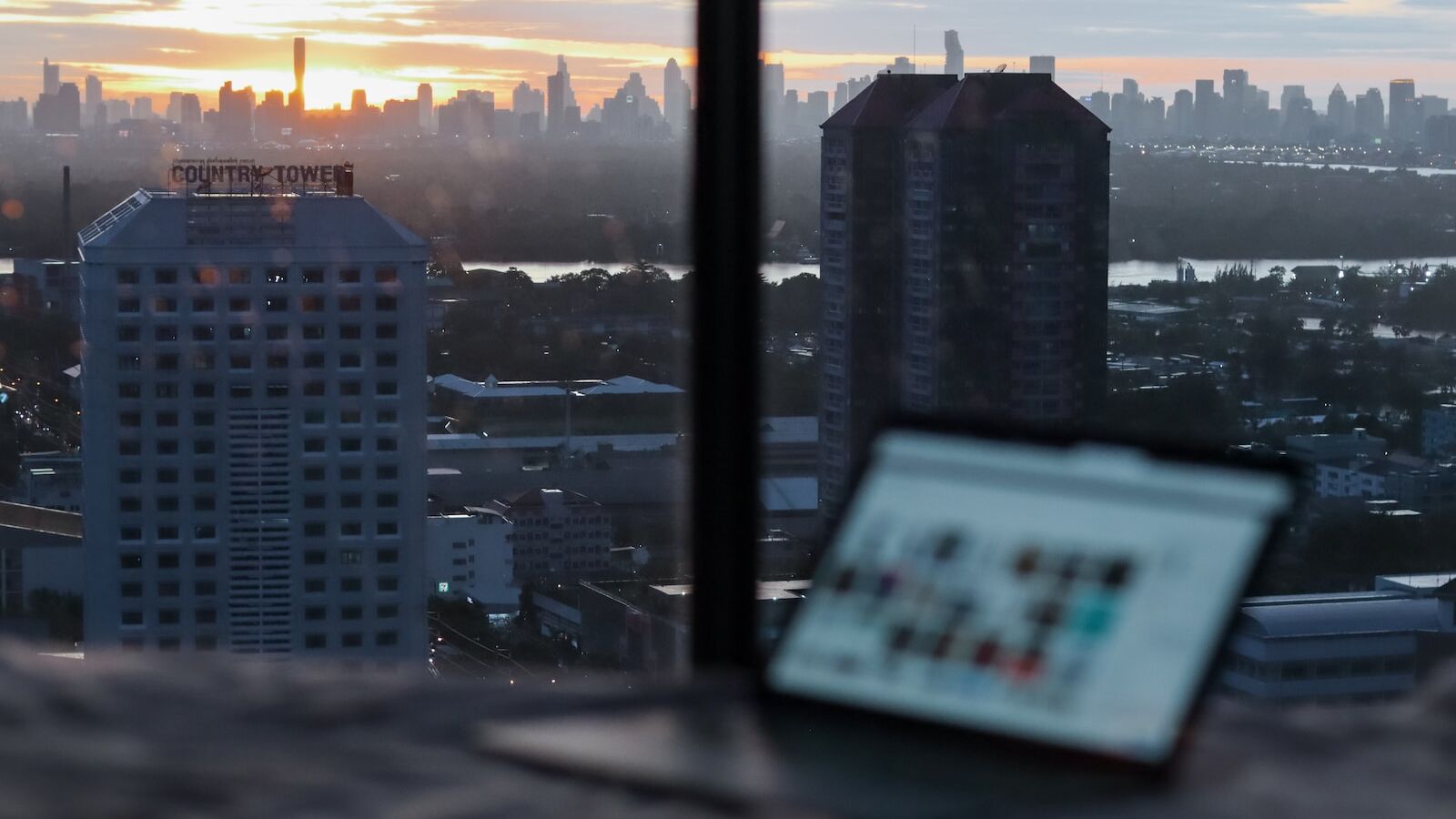 white and black high rise buildings during sunset