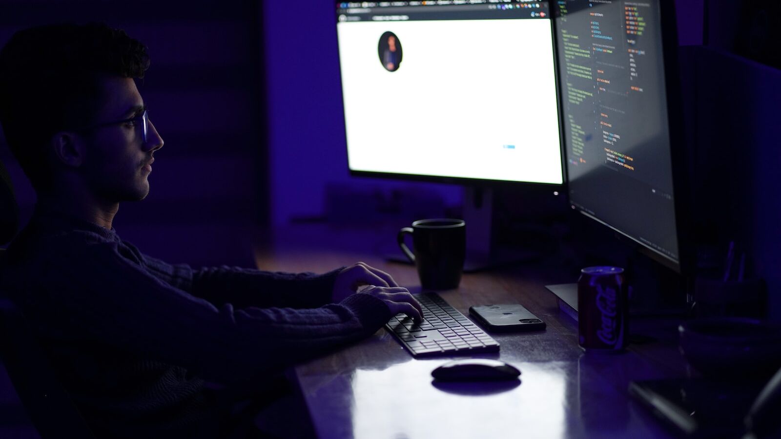a man sitting at a desk in front of a computer