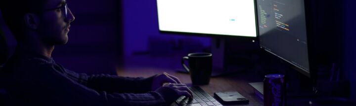 a man sitting at a desk in front of a computer