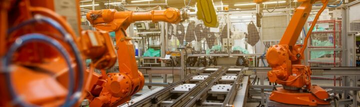 a factory filled with lots of orange machines