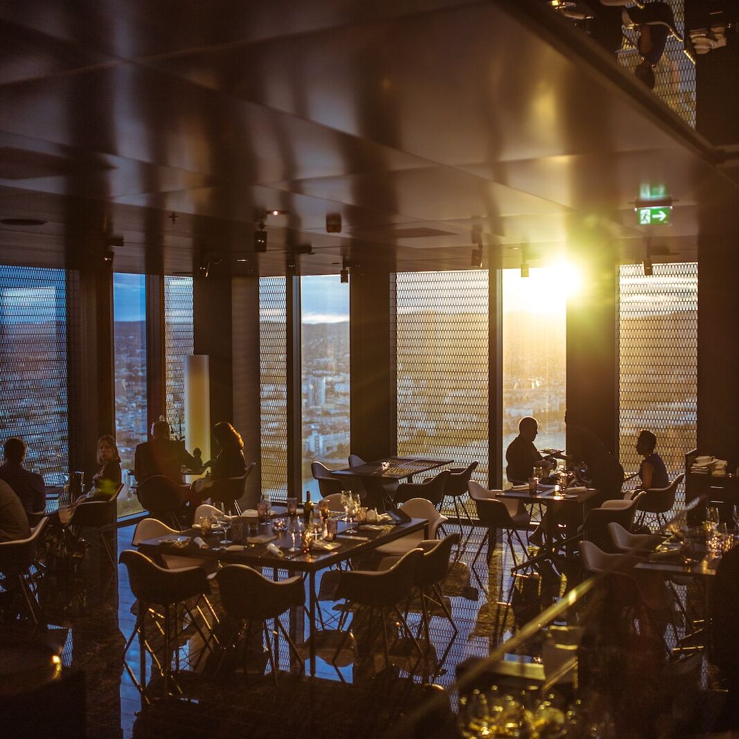 people gathering inside cafe during golden hour