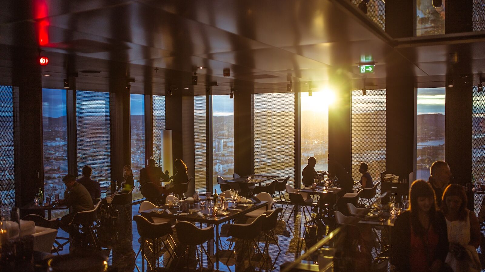 people gathering inside cafe during golden hour