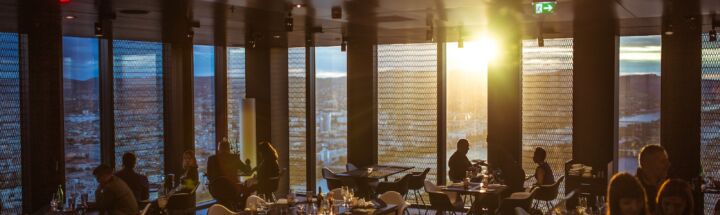 people gathering inside cafe during golden hour