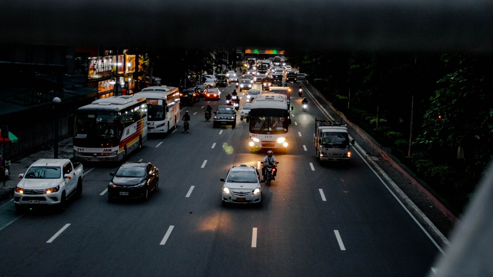a group of vehicles travel down a street