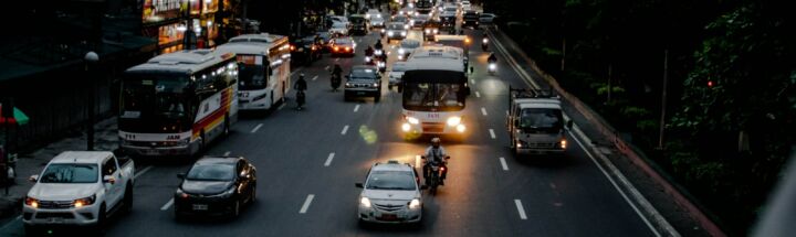 a group of vehicles travel down a street