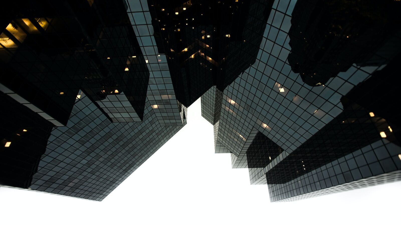 low-angle photography of building during daytime grayscale photography