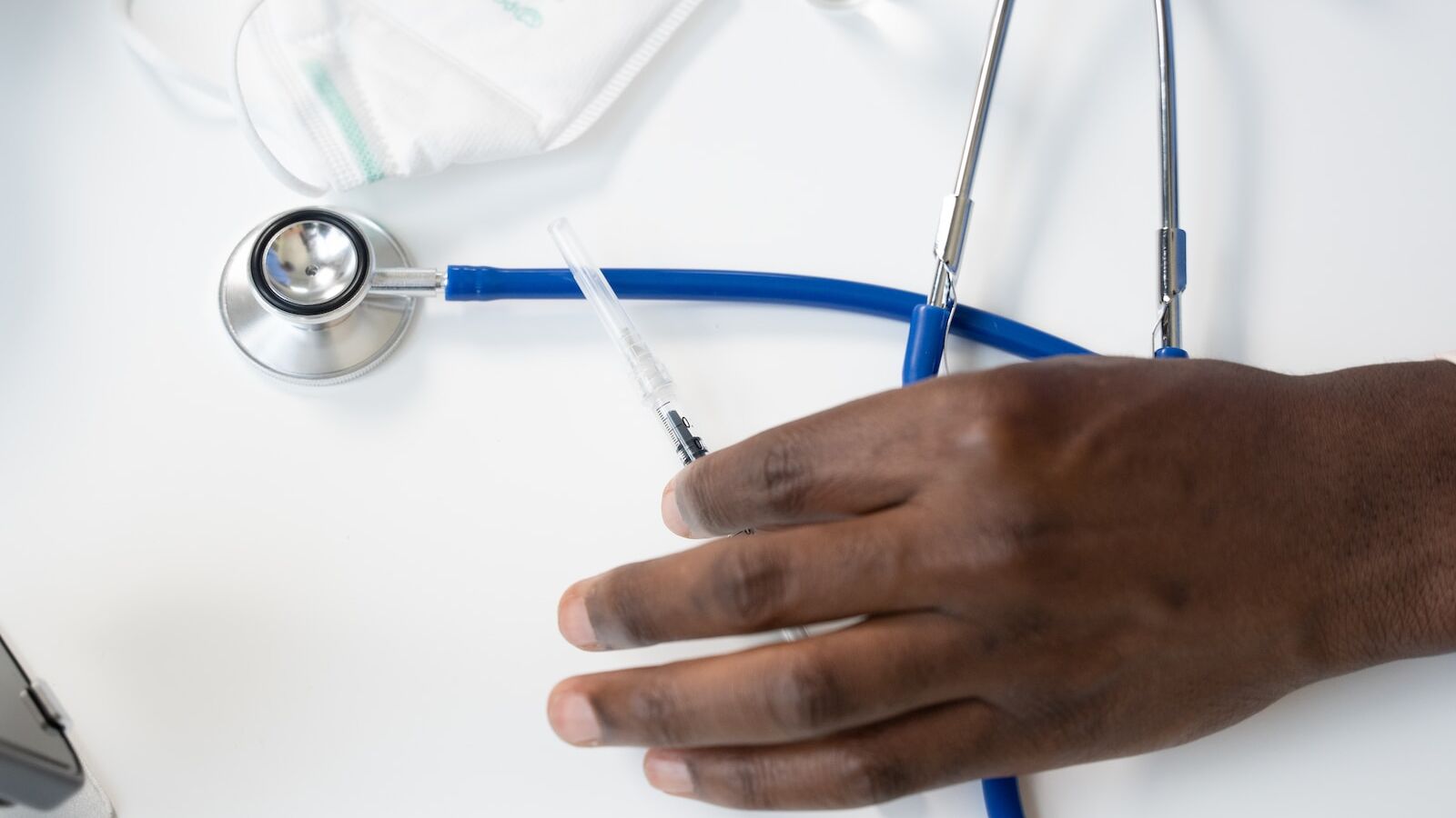 a hand holding a syringe