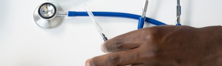 a hand holding a syringe