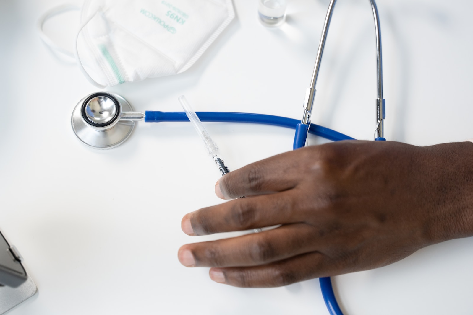 a hand holding a syringe