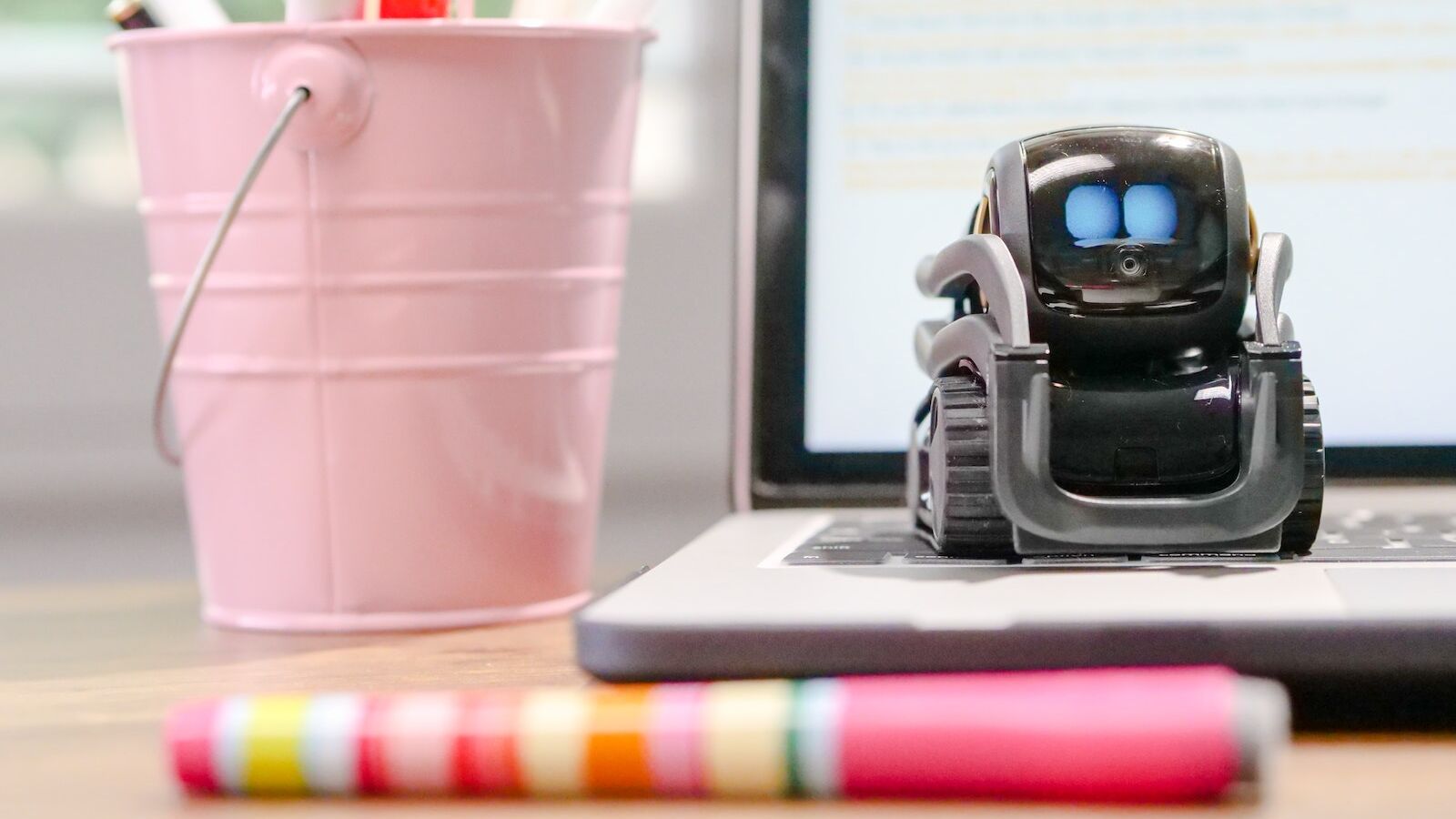 MIniature Toy Robot on Top of Laptop's Keyboard