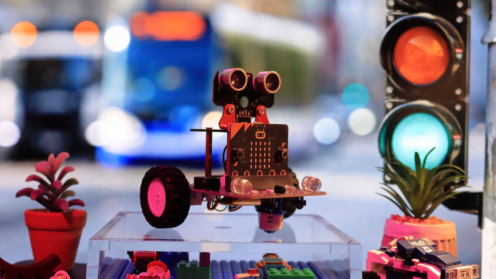 a toy robot is sitting on a table next to a traffic light