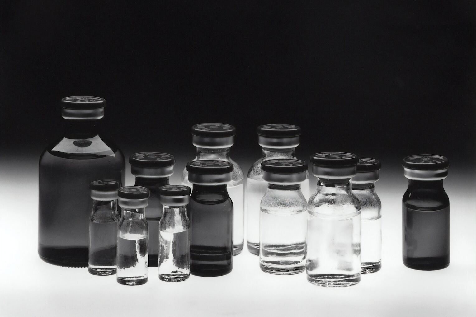 grayscale photo of glass tubes