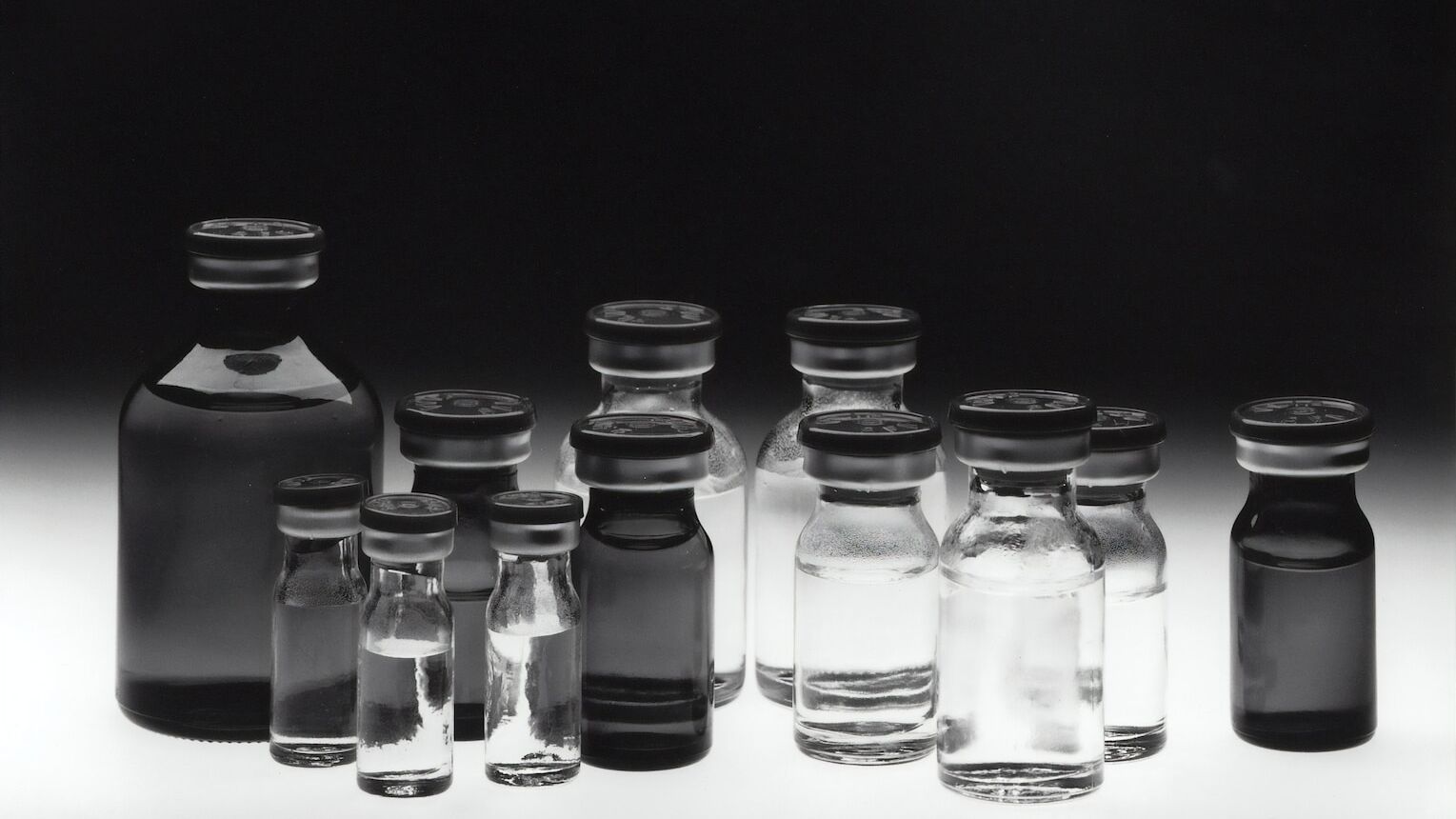 grayscale photo of glass tubes