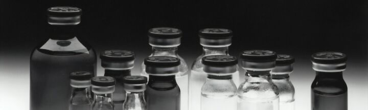 grayscale photo of glass tubes