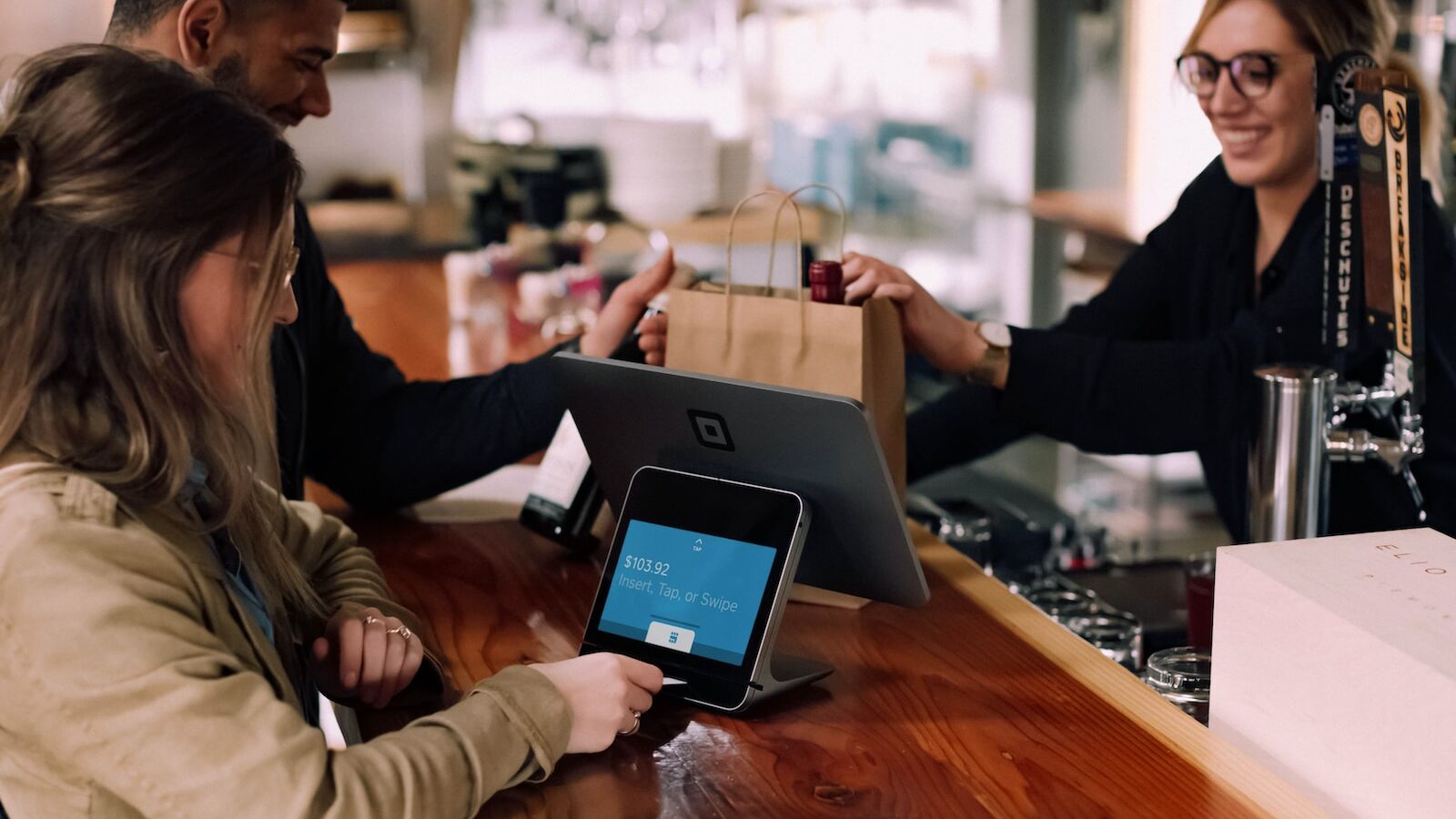 people using devices on brown table