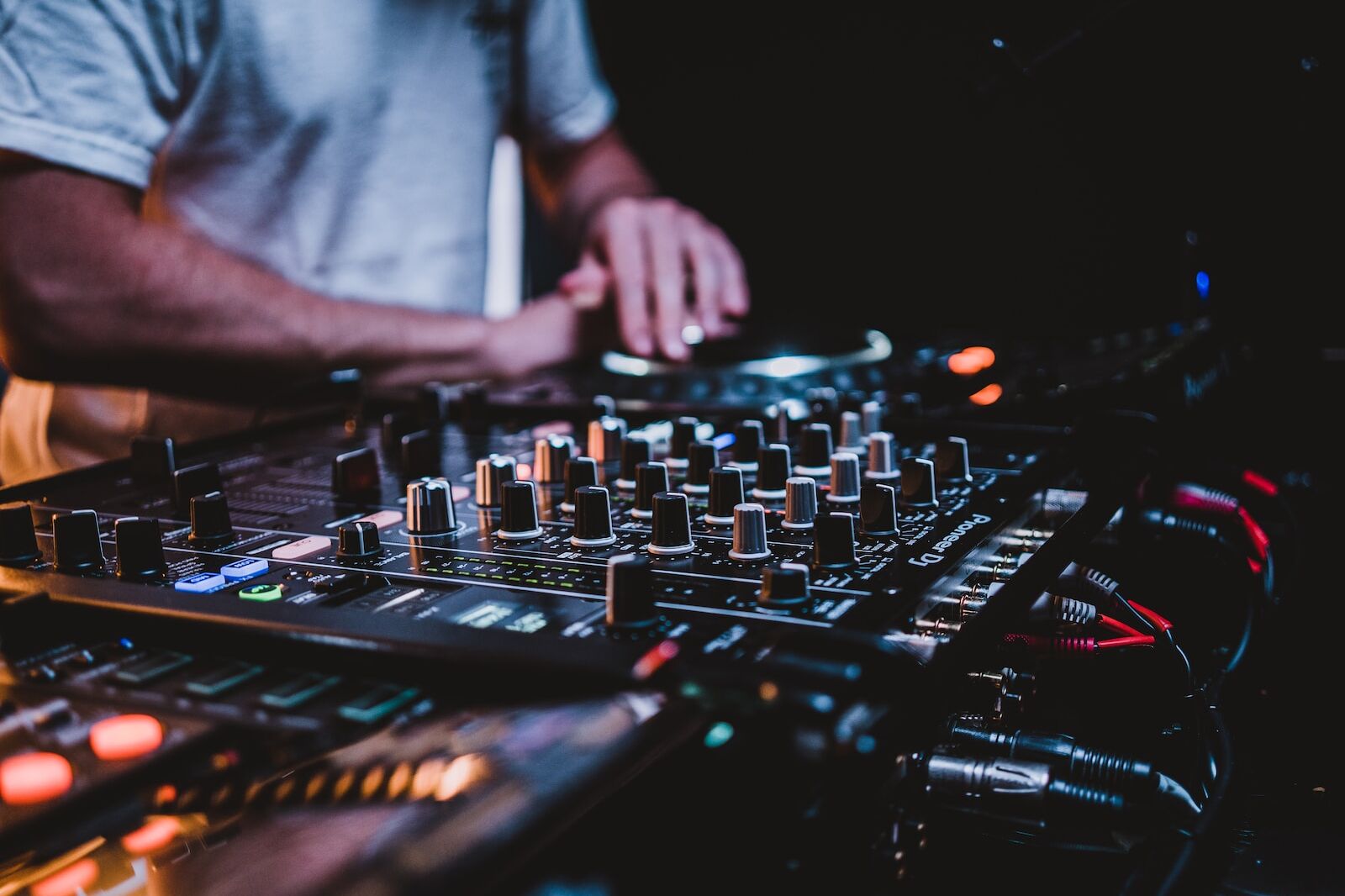 person in gray shirt playing audio mixer