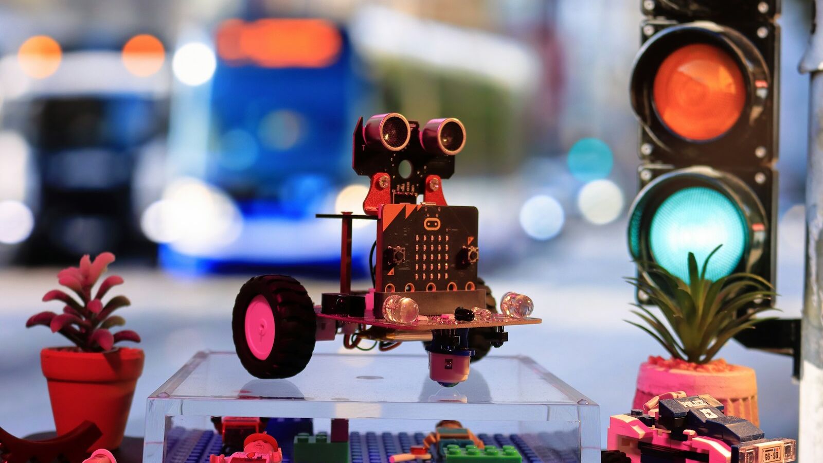 a toy robot is sitting on a table next to a traffic light