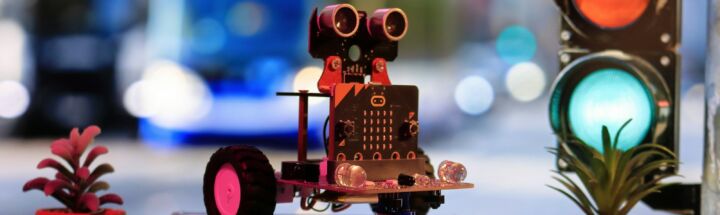 a toy robot is sitting on a table next to a traffic light