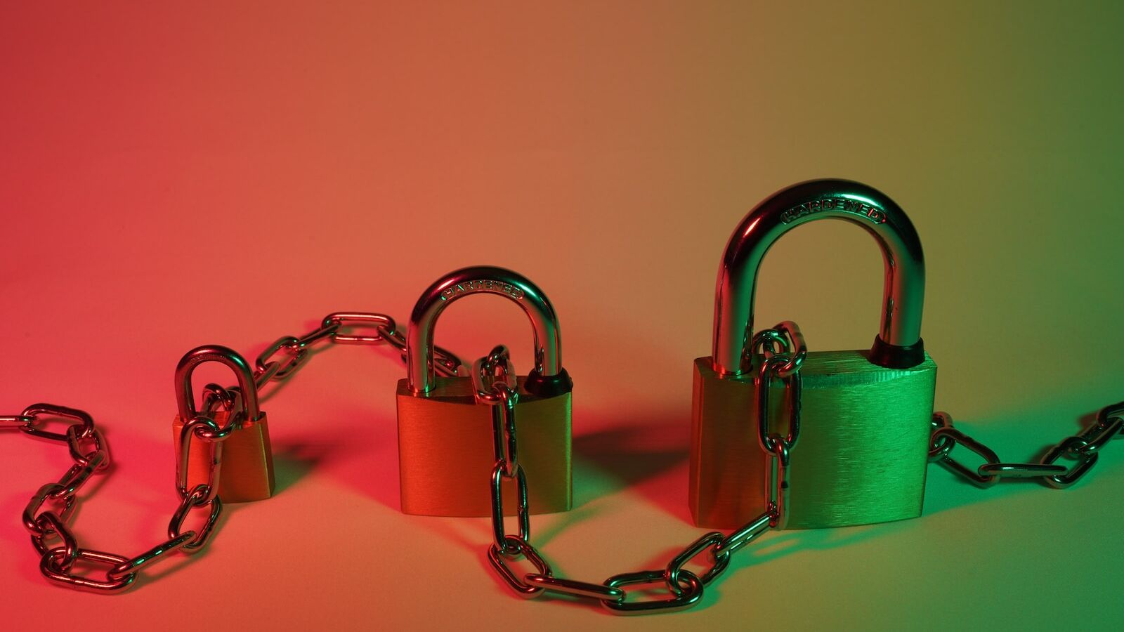 green padlock on pink surface