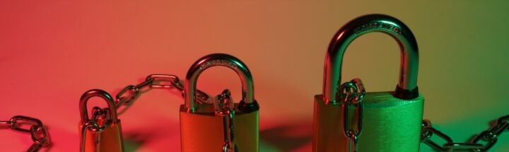 green padlock on pink surface
