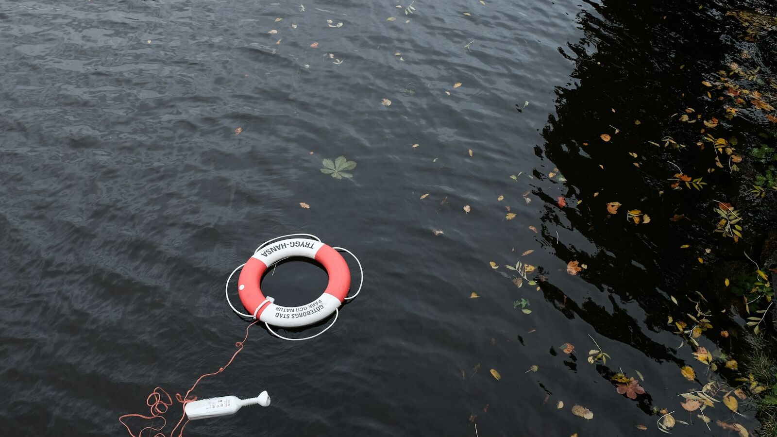 red and white bouy inflatable on water