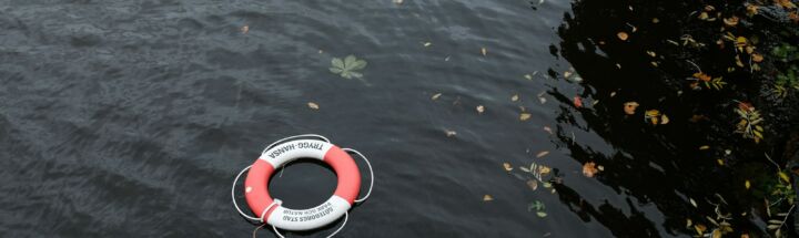 red and white bouy inflatable on water