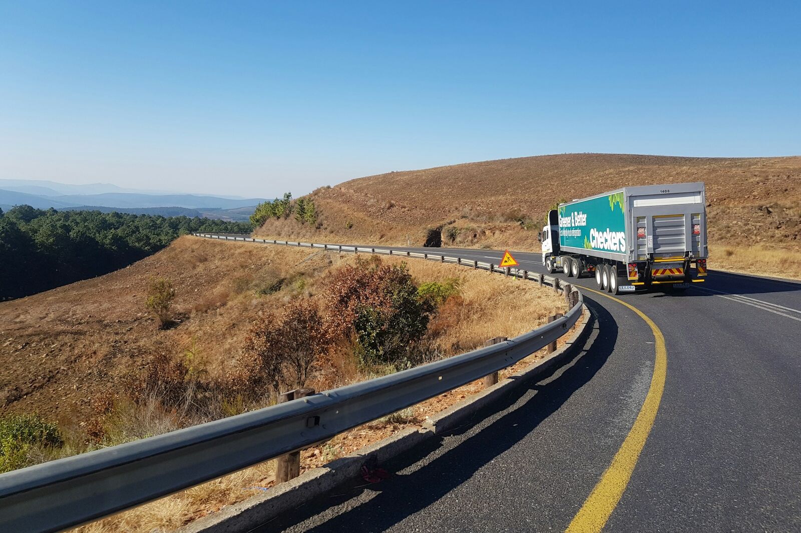 white and blue truck on road during daytime