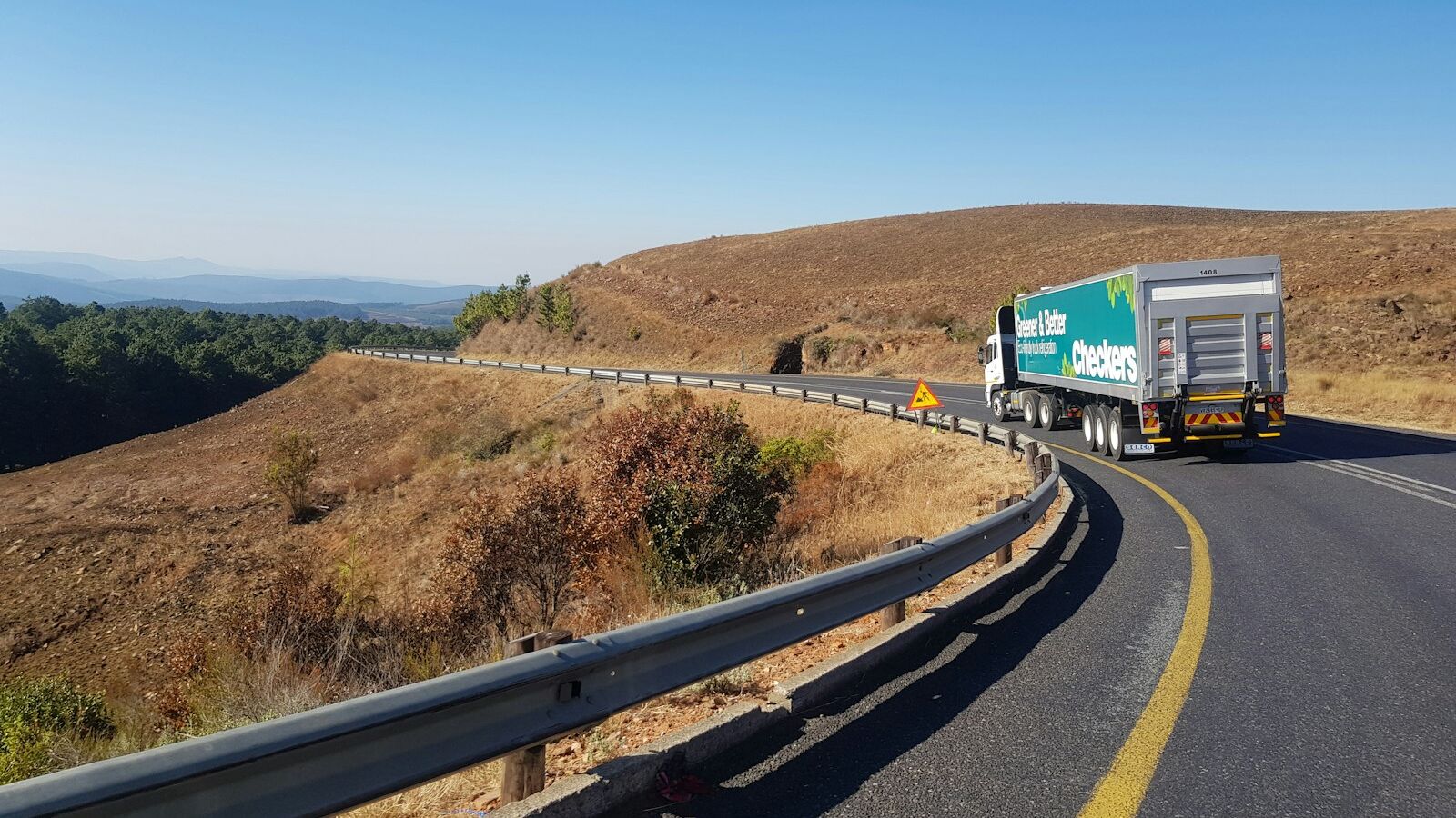 white and blue truck on road during daytime