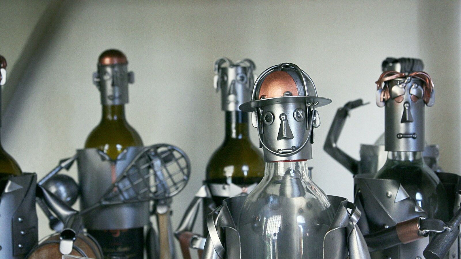 five gray-and-brown metal robots