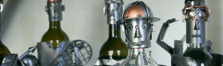 five gray-and-brown metal robots