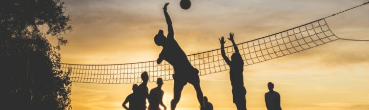silhouette of people playing basketball during sunset