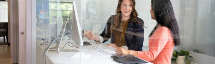 2 women sitting at table