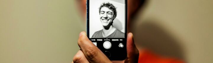 person holding space gray iPhone 5s taking picture