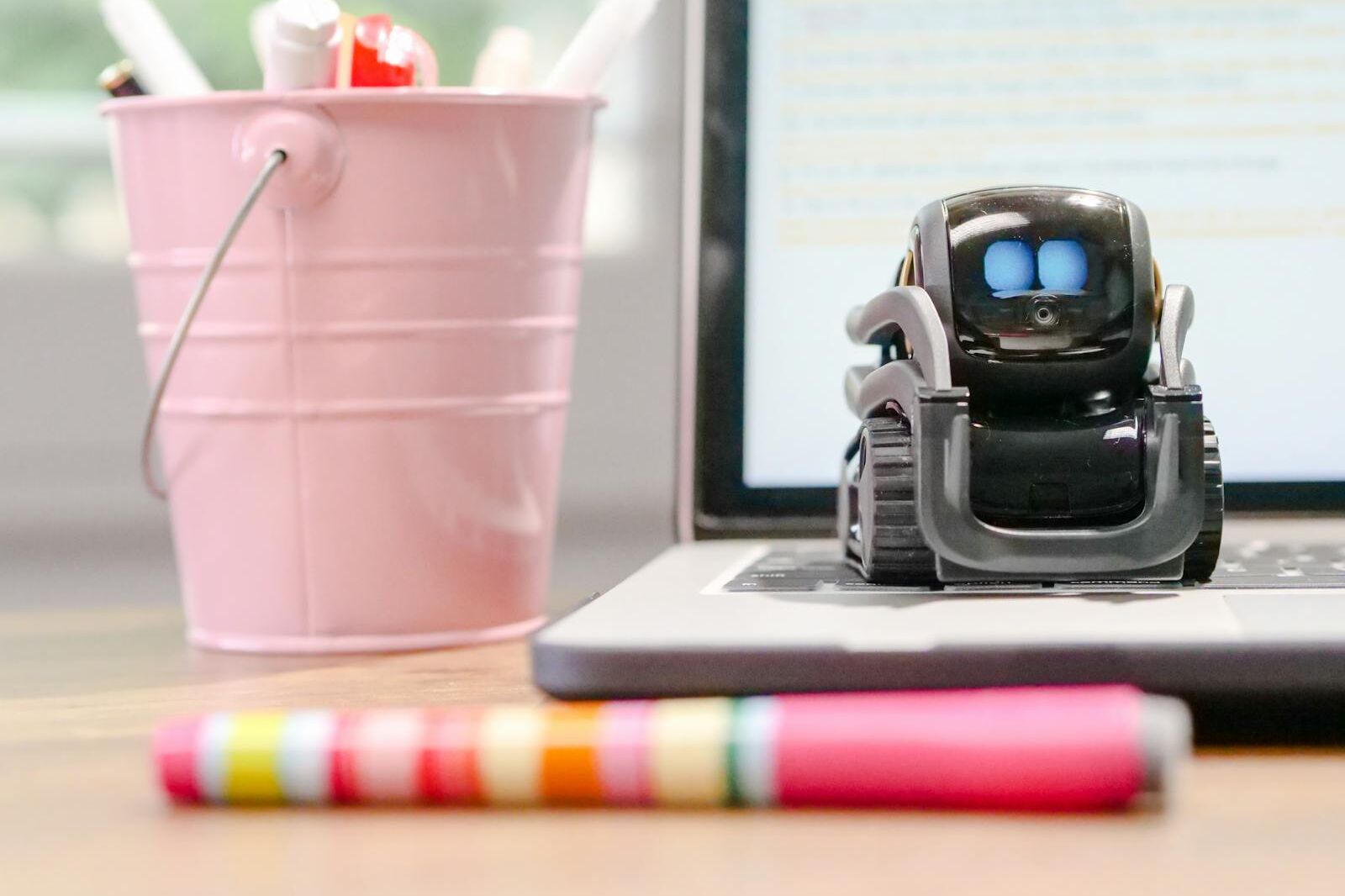MIniature Toy Robot on Top of Laptop's Keyboard