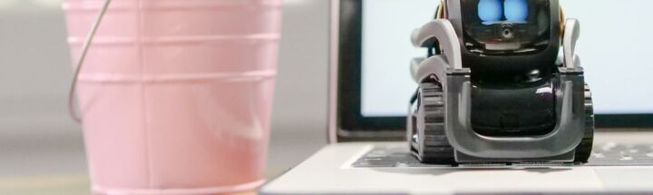 MIniature Toy Robot on Top of Laptop's Keyboard
