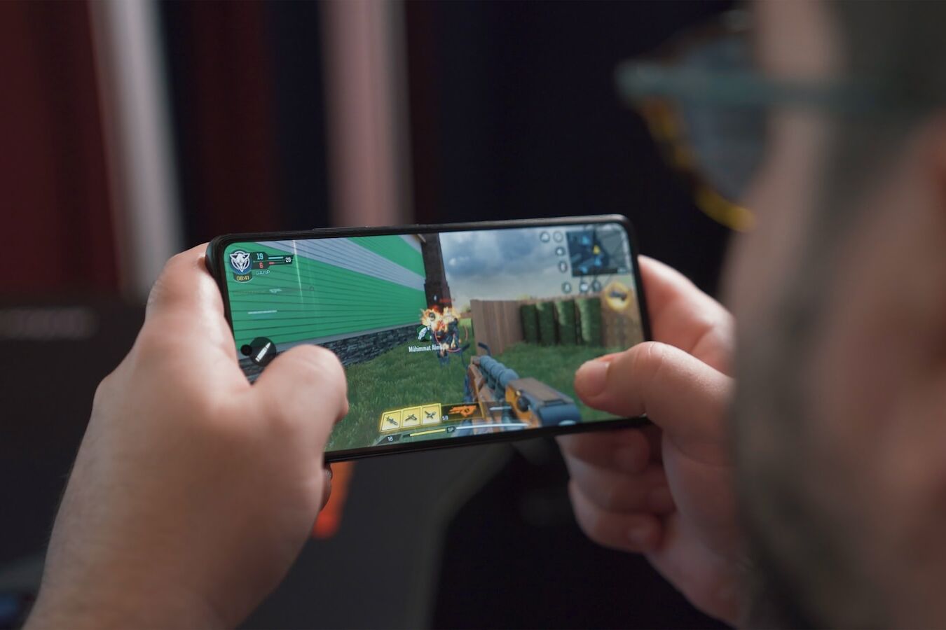 a man is playing a video game on his phone