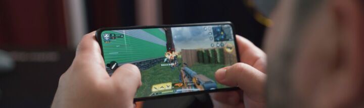 a man is playing a video game on his phone