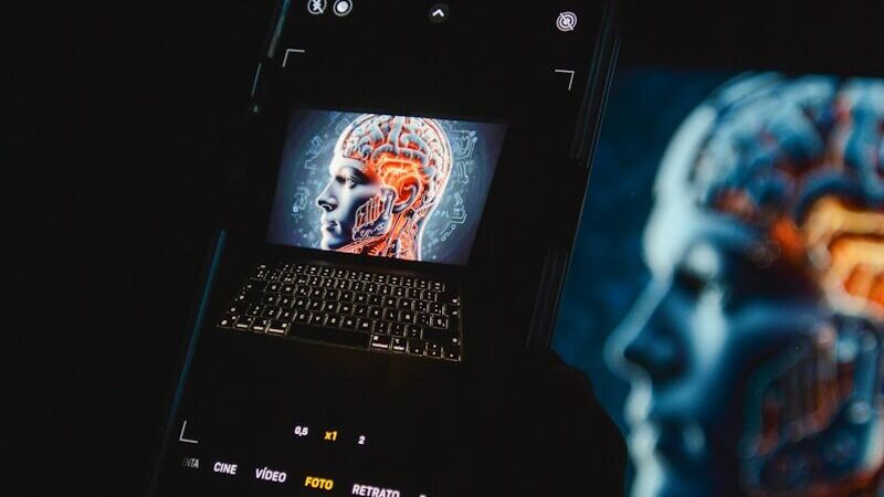 a cell phone sitting on top of a laptop computer