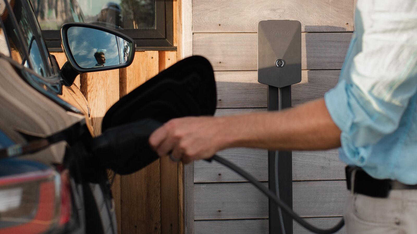 a man pumping gas into his car at a gas station