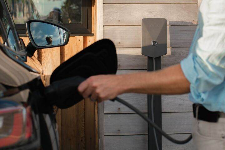 a man pumping gas into his car at a gas station