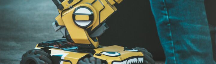 yellow and black 4-wheeled robot vehicle toy