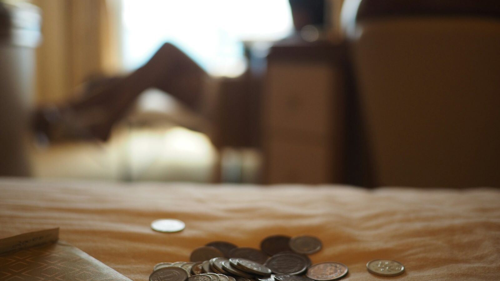 silver coins on brown wooden table