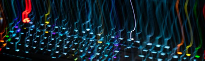 a close up of a computer keyboard with colorful lights