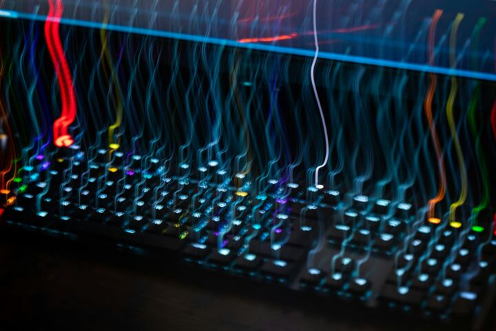 a close up of a computer keyboard with colorful lights