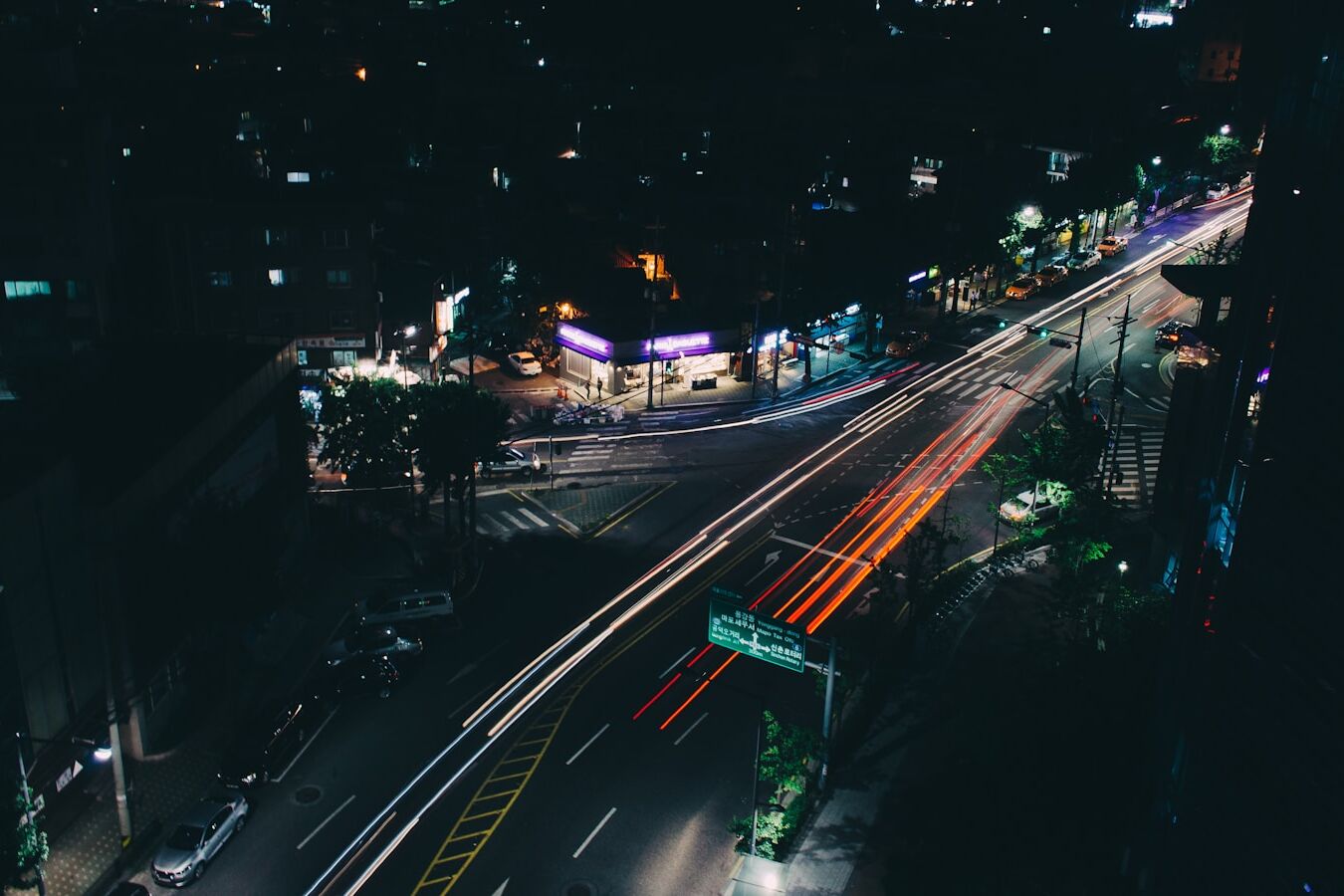 timelapse photography of vehicle passing on road at nighttime