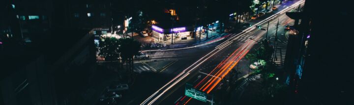 timelapse photography of vehicle passing on road at nighttime