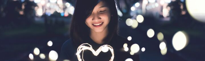 A woman holding a heart