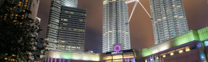 people walking on street near high rise buildings during night time