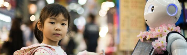 photo of girl laying left hand on white digital robot